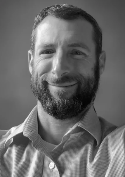 Professional portrait of Michael Sher, looking thoughtful and approachable.